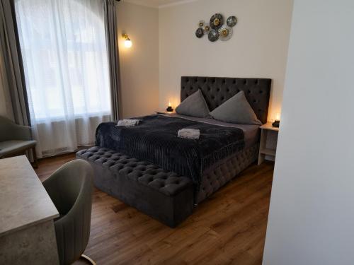 a bedroom with a bed and a couch in a room at Boutique Hotel in Bad Salzuflen