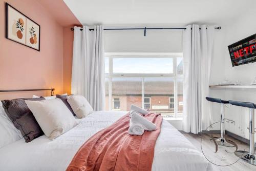 a bedroom with a bed and a large window at Gorgeous Longton Studio 2a in Stoke on Trent