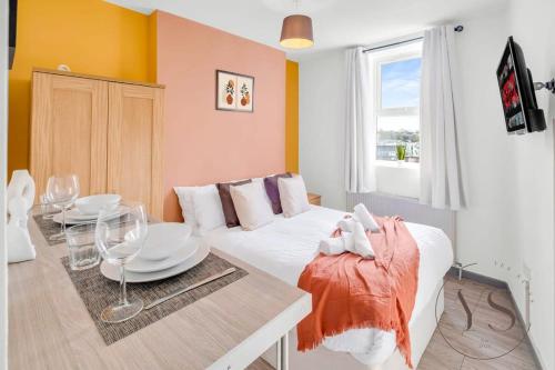 a living room with a white couch and a table at Sienna Studio 1E Near Alton Towers with Free Wi-Fi and Netflix Access in Stoke on Trent