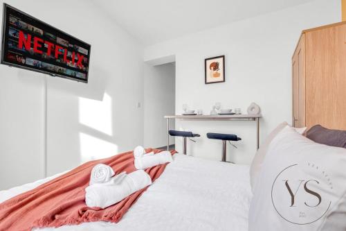 a bedroom with a bed with two towels on it at Sienna Studio 1E Near Alton Towers with Free Wi-Fi and Netflix Access in Stoke on Trent