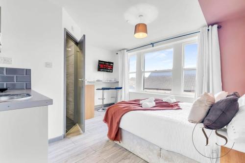 a bedroom with a bed and a large window at Gorgeous Longton Studio 2d in Stoke on Trent