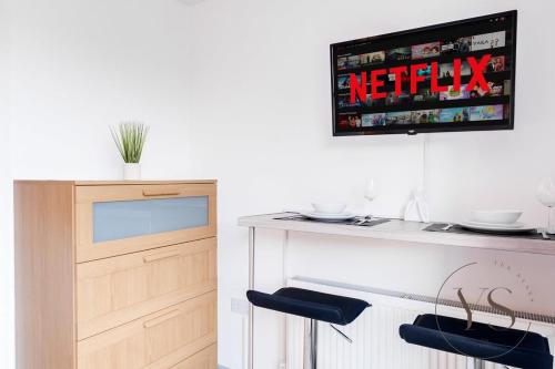 a kitchen with a table and a tv on the wall at Bright 2D Studio in Longton Near Alton Towers with Smart TV and Self Check-In in Stoke on Trent