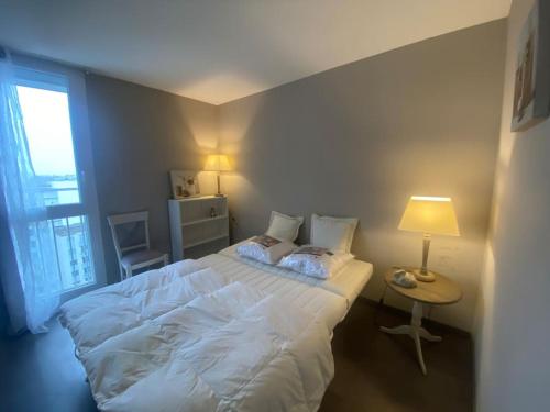 Un pat sau paturi într-o cameră la Panorama Lillois, Concierge-City