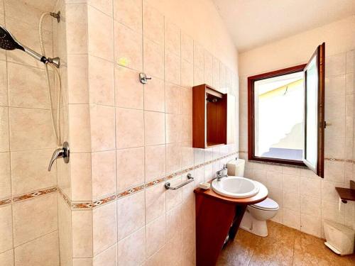 a bathroom with a toilet and a shower and a sink at Natural Home, Villasimius in Villasimius