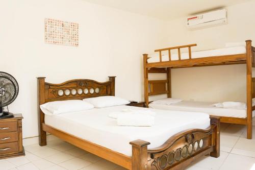 two bunk beds in a room with white walls at Hostal Paraiso Tayrona in Santa Marta