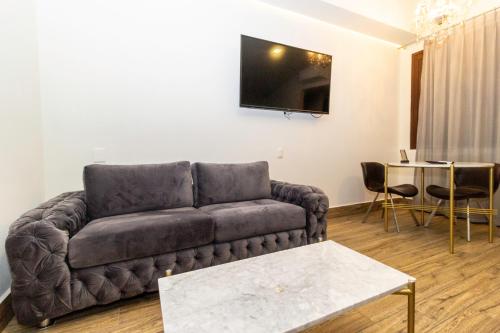 a living room with a couch and a table at Hotel Boutique Naura Centro in Oaxaca City