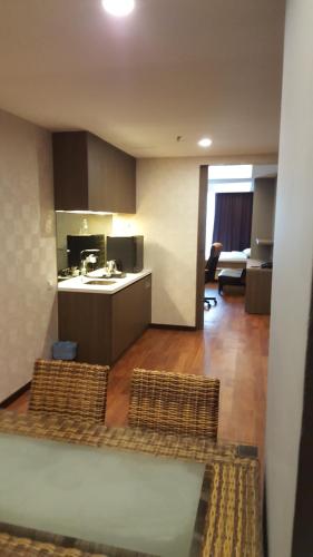 Ένα ή περισσότερα κρεβάτια σε δωμάτιο στο Nexus Business Suite Hotel
