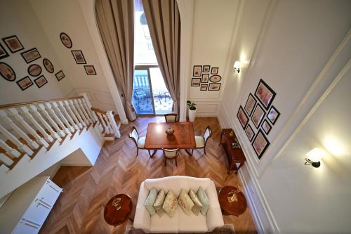 a living room with a white couch and a table at 21 High Street Residence By The Torch in Doha