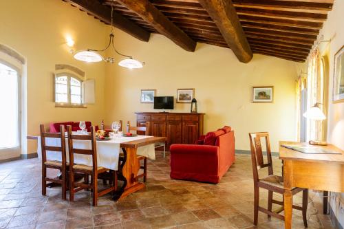 a kitchen and dining room with a table and chairs at Villa Le Beringhe - Wine Pool & Relax in Colle di Val d'Elsa