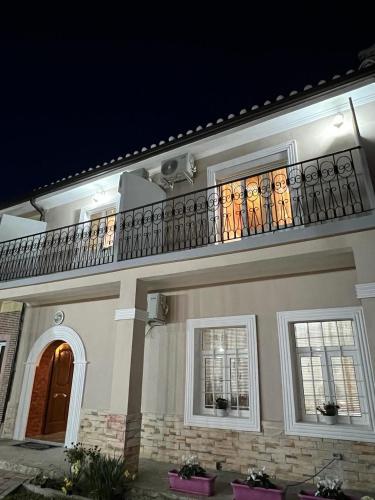 a large house with a balcony on top of it at Garden Villa Guni in Krujë