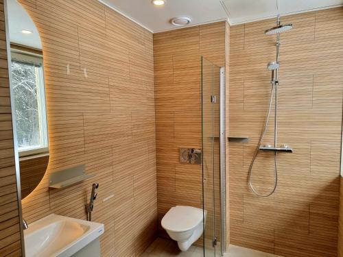 a bathroom with a shower and a toilet and a sink at EnjoyNature B&B in Lahti