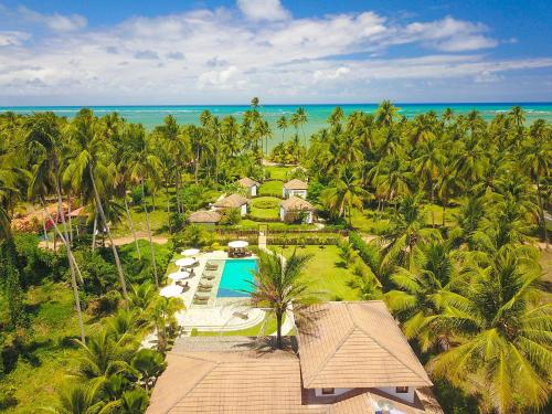 an aerial view of a resort with a pool and palm trees at Pousada Samba Pa Ti in Pôrto de Pedras