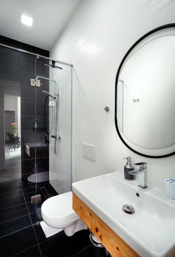 a bathroom with a sink and a shower at Erkan Alek Heritage Hotel in Gyumri