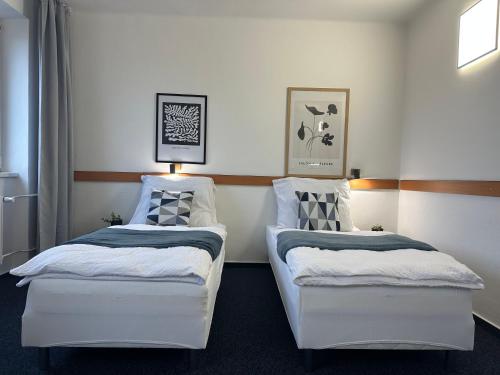 two beds sitting next to each other in a room at Morava 305 Uherské Hradiště Šafaříkova 855 in Uherské Hradiště