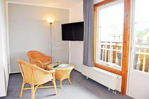 a room with two chairs and a table and a window at Hotel InselGlück - Restaurant & Cafè in Lohme