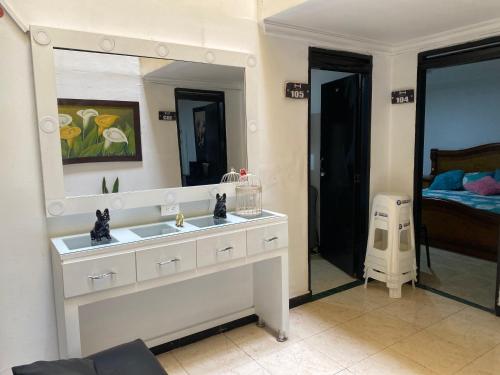 un baño con lavabo y espejo en Hotel Estadio Suite, en Medellín