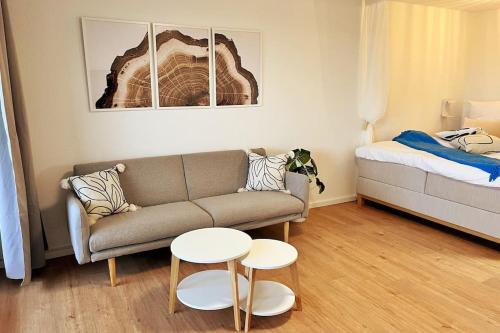 a living room with a couch and a bed at Apartment mit Weitblick in Löffingen