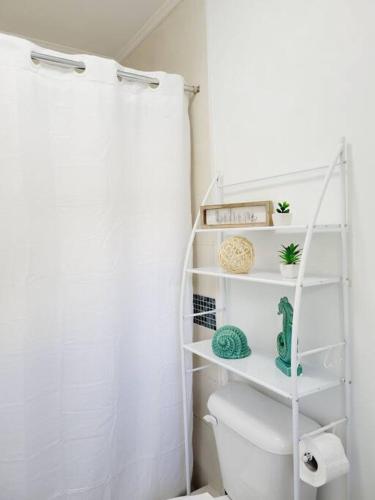 a white bathroom with a toilet and a shower at Studio Soliá-Slice Of Paradise in Bridgetown