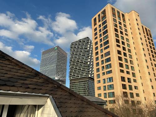a group of tall buildings in a city at Villa Hotel Frankfurt by MZ HotelCollection in Frankfurt