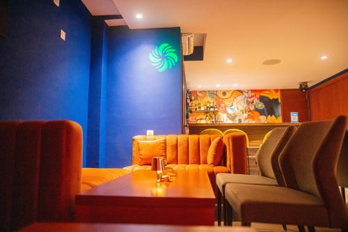 a restaurant with chairs and a table in a room at The Six in Cocody