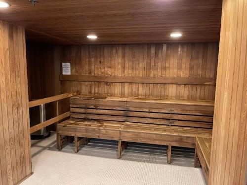 a sauna with a wooden bench in a room at Gastown Downtown Apartment very central in Vancouver