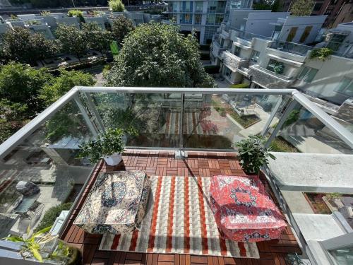 a glass balcony with pillows on the floor of a building at Gastown Downtown Apartment very central in Vancouver