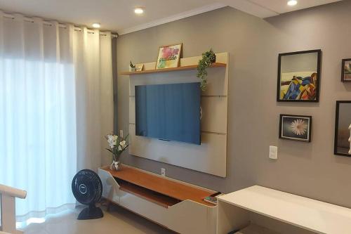 a living room with a flat screen tv on the wall at Casa linda, luxo e aconchegante in Blumenau
