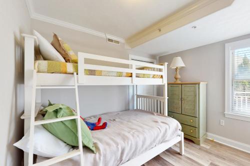 a bedroom with white bunk beds in a room at OC Condo 4100 #103 in Ocean City