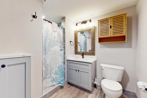 a bathroom with a toilet and a sink and a shower at OC Condo 4100 #103 in Ocean City