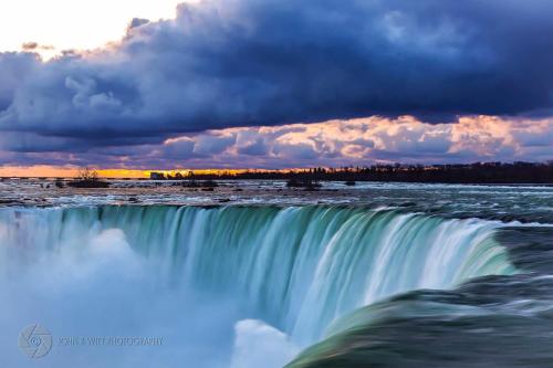 a waterfall in the middle of a body of water at Niagara Stone Bliss in Niagara Falls