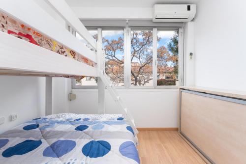 a bedroom with a bunk bed and a window at La Sagrera House in Barcelona