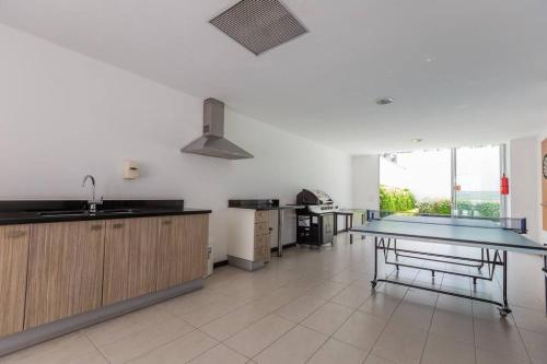 a large kitchen with a sink and a counter at Villa Azul Apartment in Quito