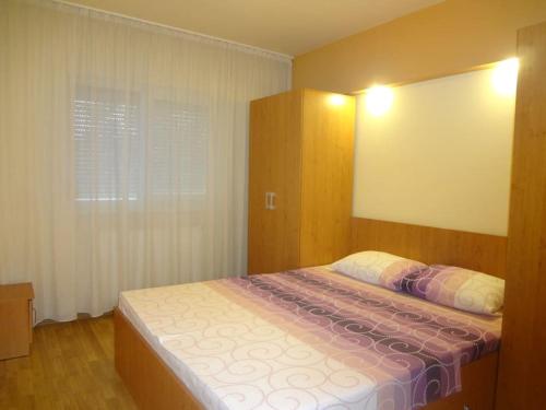 a bedroom with a bed and a large window at Apartment Dan Timisoara - two bedrooms in Timişoara