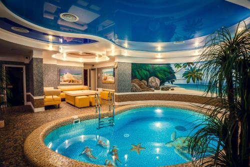 a large swimming pool in a hotel room with a swimming pool at Sofievsky Posad Hotel in Kyiv