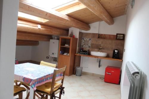 a kitchen with a table and a sink in a room at La Dimora di Ziella in Barisciano