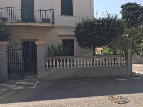 a fence in front of a building with a gate at A due passi dal mare in Castiglioncello