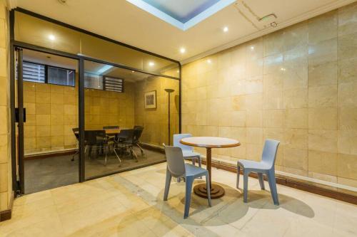 a room with a table and chairs and a dining room at Akros Galapagos Suite in Quito
