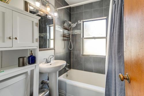 a bathroom with a sink and a tub and a window at Inviting Aurora Vacation Rental about 7 Mi to Denver! in Aurora