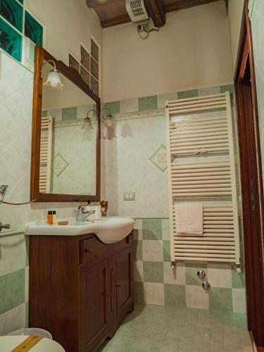 a bathroom with a sink and a mirror at B&B Villa Erika in Lugo