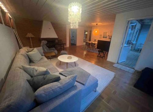 a living room with a couch and a table at Cozy house near the sea in Höllviken