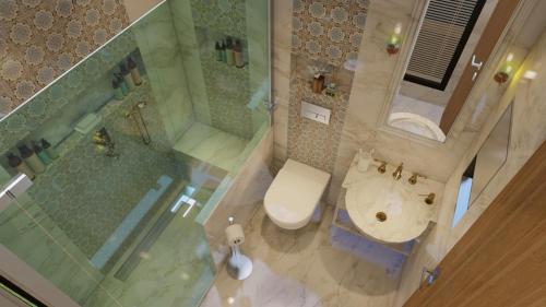 an overhead view of a bathroom with a toilet and a shower at Lotus Airport Hotel in İmrahor