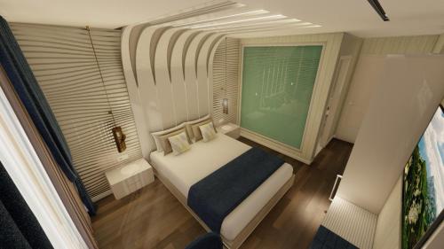 a small bedroom with a bed and a window at Lotus Airport Hotel in İmrahor