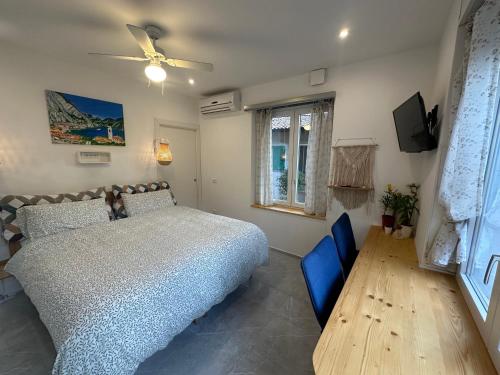 a bedroom with a bed and a television in it at B&B Casa Limone in Limone sul Garda