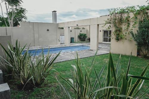 a house with a swimming pool in a yard at Sarmiento Suites Premium in Salta