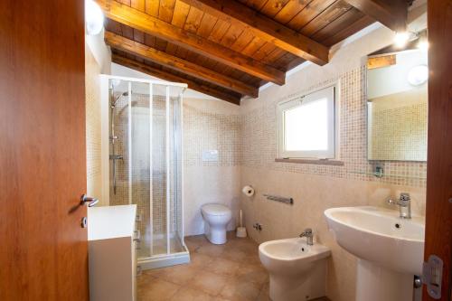 baño con lavabo y aseo y ventana en Villetta Fiore B&B, en Cutrofiano