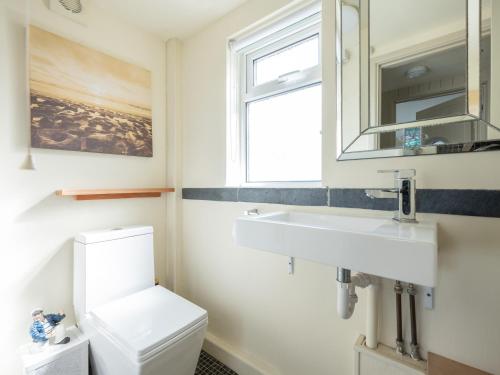 a bathroom with a sink and a toilet at Beachside in Polzeath