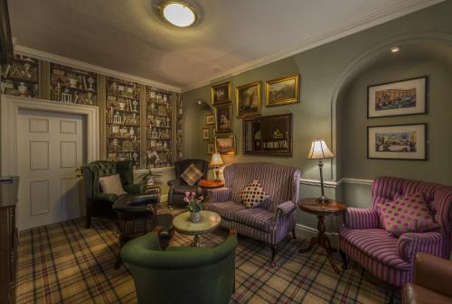 a living room with couches chairs and a table at Washingborough Hall Hotel in Lincoln