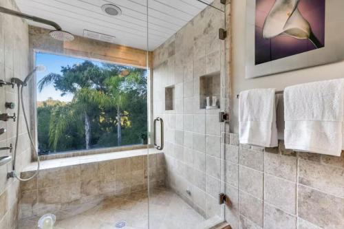 a bathroom with a shower and a window at The Malibu Retreat Private Compound w/ Salt Water Pool + Views in Malibu