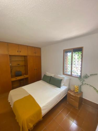 a bedroom with a large bed and a window at Pink Lemon House in Elche