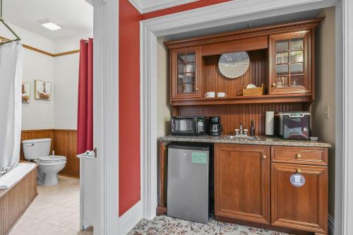 a kitchen with a sink and a refrigerator at The Pasfield House in Springfield